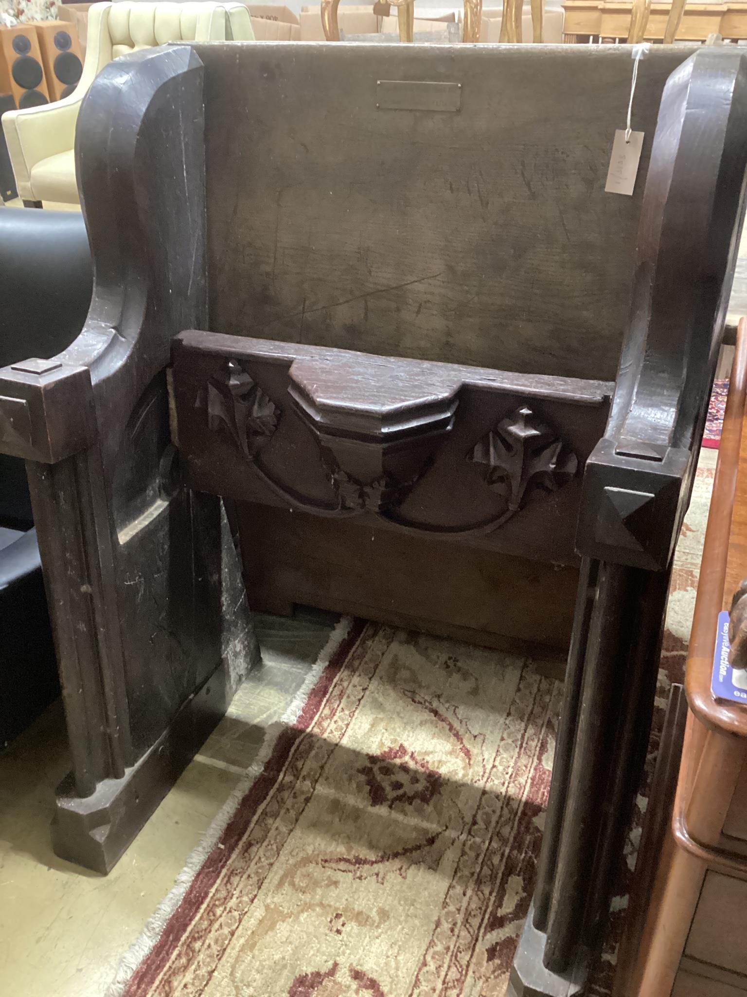 A 17th century and later oak pew with carved misericord, width 82cm, depth 40cm, height 109cm